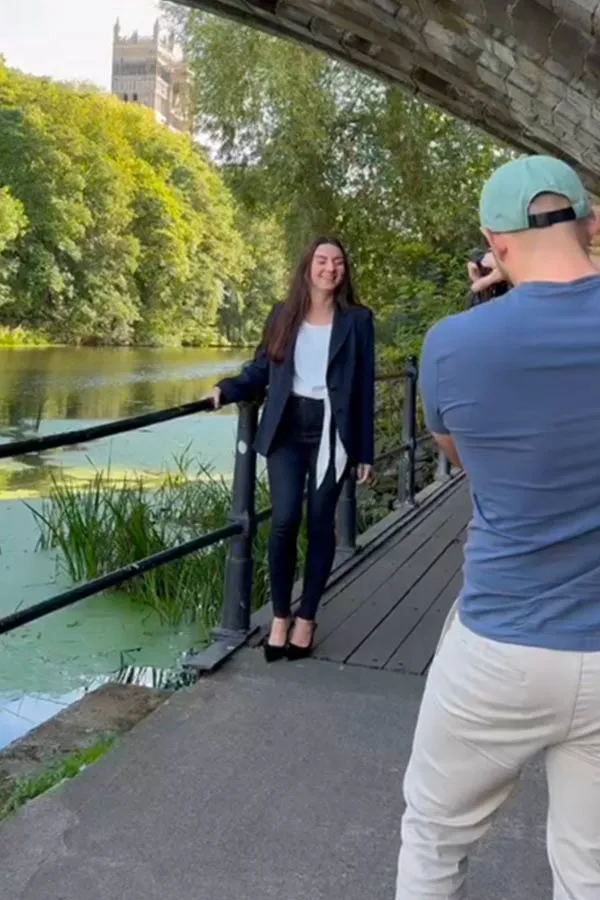 A photographer shooting a portrait of a woman by the river in Durham